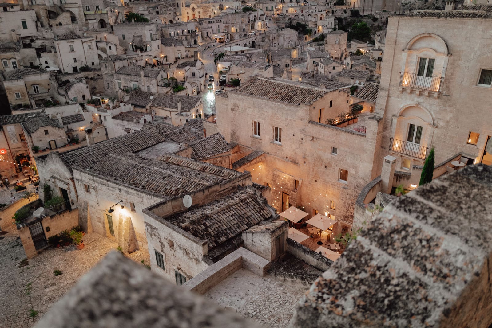 A lane in Matera's centro storico at dusk, near the apartment